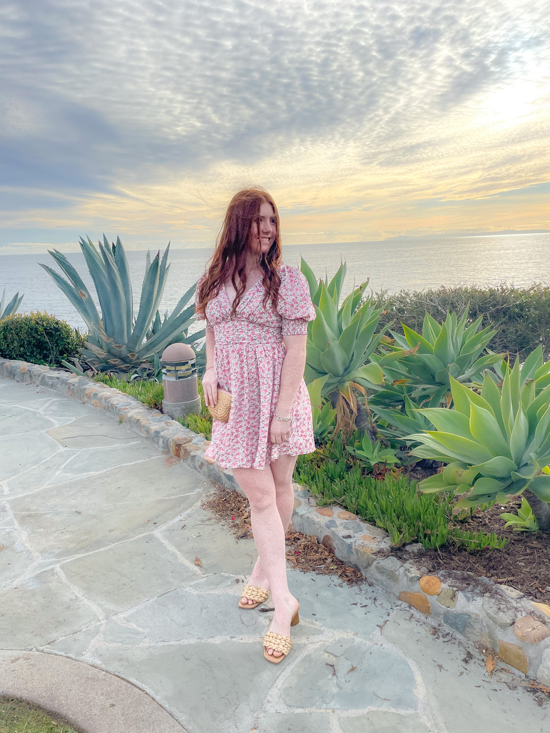 floral pink printed dress with its mini length, V neckline, and fitted ruched waist and puff sleeves 