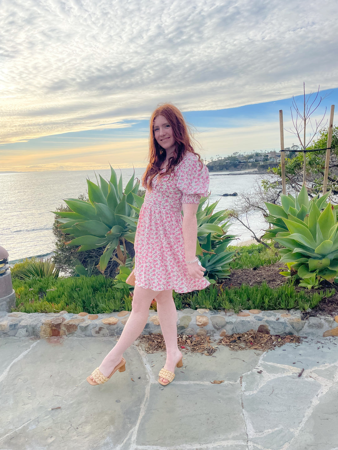 floral pink printed dress with its mini length, V neckline, and fitted ruched waist and puff sleeves 