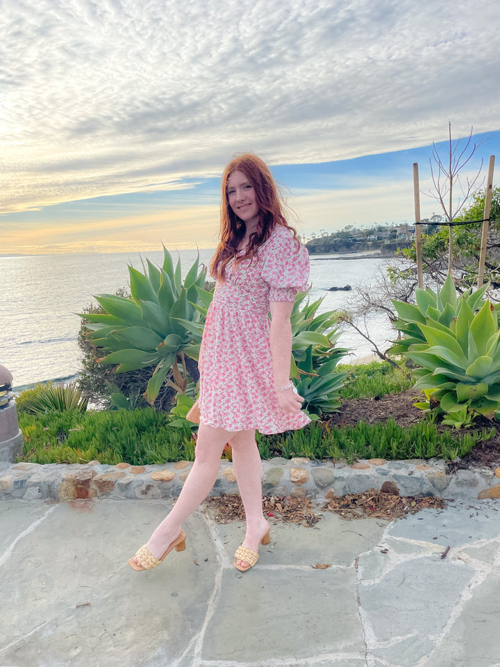 floral pink printed dress with its mini length, V neckline, and fitted ruched waist and puff sleeves 