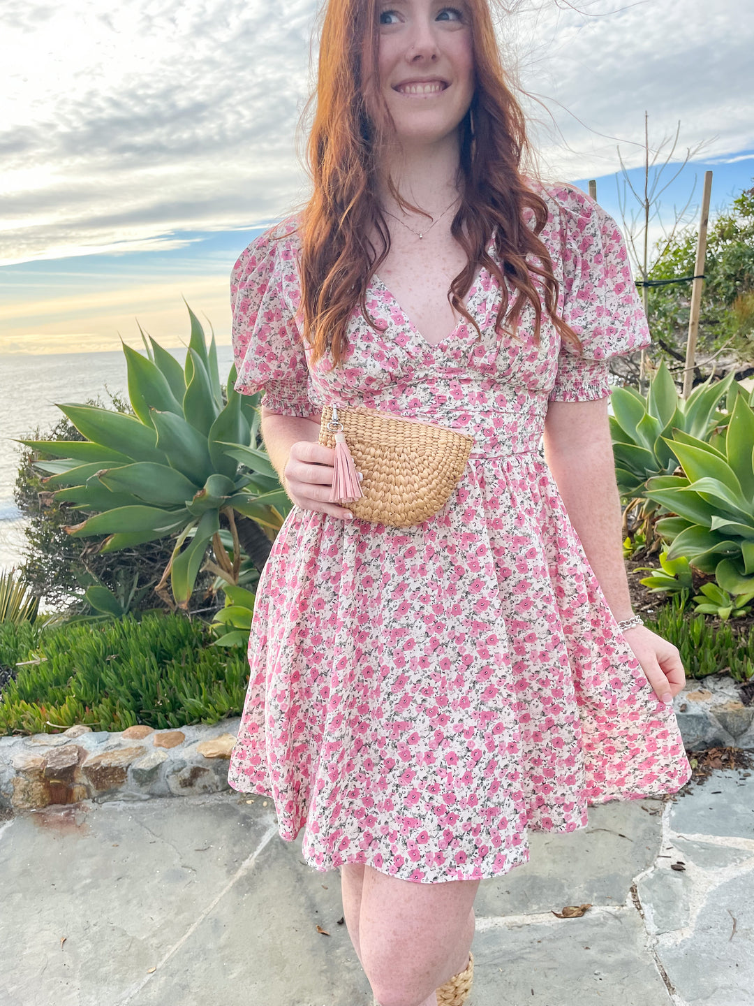 floral pink printed dress with its mini length, V neckline, and fitted ruched waist and puff sleeves 